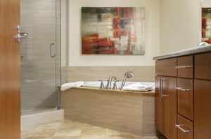 Extra large soaker tub next to the glass panel shower