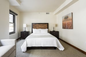 Queen guest bedroom, unique wooden headboard, bedside tables and table lamps