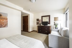 Queen bed plus queen sofa sleeper, wooden chest of drawers with flat screen TV