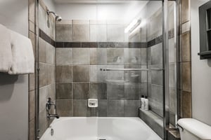Shower tub combo in the final guest bathroom