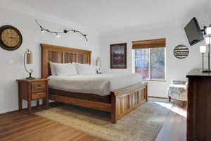 The main suite has a king size bed with gorgeous wood bed frame and well appointed furniture and decor.