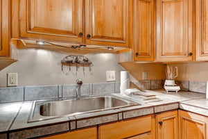 The well equipped kitchen with wood cabinets.