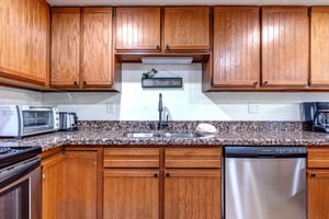 The kitchen has a two basin kitchen sink with good task lighting mounted under the cabinet.
