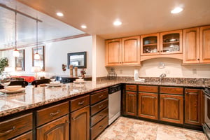 The wellequipped kitchen has wood cabinets and stainless steel appliances.