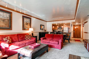 Park Station 139 has a living room with red suede couches.