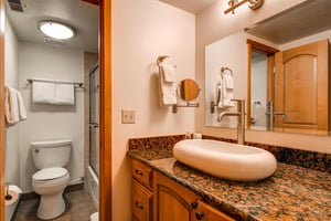 The shared bathroom has a single sink vanity and separate water closet.