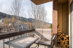 The private balcony offers mountain views and a sitting area.