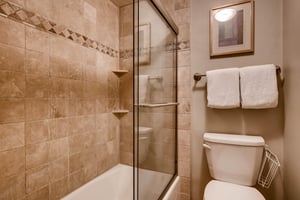The en suite bathroom has a separate water closet with bathtub and shower combination.