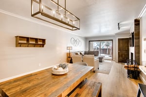Solid wood dining room table with wooden dining bench, opens to the living room