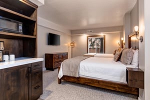 The second bedroom features two queen beds, large picture window, and coffee makermicrowave nook
