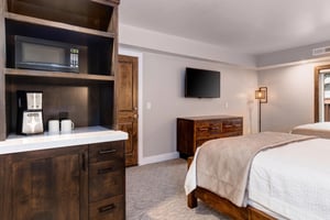 Guest bedroom complete with a coffee maker, microwave, and mini fridge