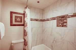 The second bedroom shares a bathroom with a bathtub and shower combination and toilet.