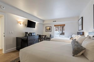 This hotel style room that offers two queen size beds and coffee maker and microwave..