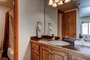 The shared bathroom has a single sink vanity and separate water closet.
