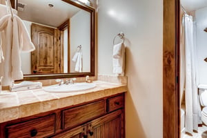 The shared bathroom has a single sink vanity.