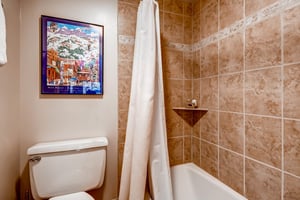 The shared bathroom has a bathtub and shower combination.