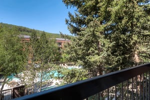 A private balcony has seating for two and views of the mountain.