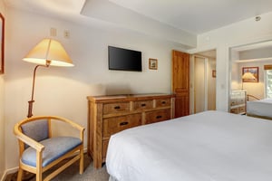 One of the bedrooms offers a kingsize bed and wood furniture.