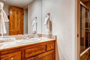 The shared bathroom has a single sink vanity and separate water closet.