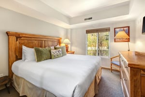 One of the bedrooms offers a kingsize bed and wood furniture.