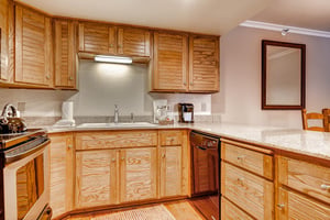 The wellequipped kitchen offers stainless steel appliances and wood cabinets.