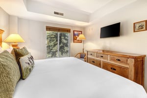 One of the bedrooms offers a kingsize bed and wood furniture.