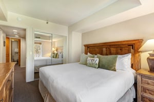 One of the bedrooms offers a kingsize bed and wood furniture.