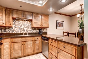 The wellequipped kitchen offers stainless steel appliances and wood cabinets.