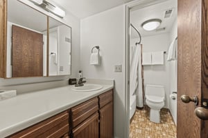 The shared bathroom has a single sink vanity and a separate water closet.