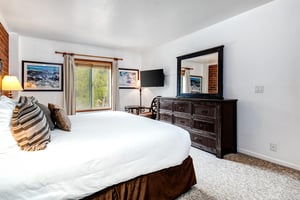 One of the bedrooms offers a kingsize bed and wood furniture.