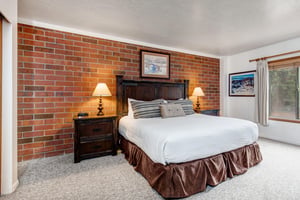 One of the bedrooms offers a kingsize bed and wood furniture.