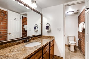The shared bathroom has a single sink vanity and separate water closet.