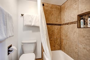 The shared bathroom has a single sink vanity and separate water closet.
