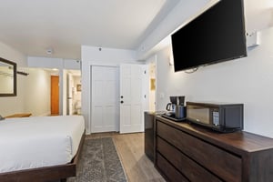 The second bedroom has two queen size beds and flat screen TV.