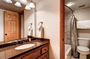 The shared bathroom has a single sink vanity and separate water closet.