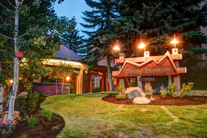 Park Station Condominiums steps leading to a covered entry with black lamp posts lighting the way.