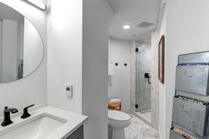 The en suite bathroom with a single sink vanity and walkin shower.