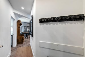 The main entry door with an area to hand coats and put shoes.