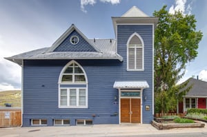 The exterior of the historic Blue Church Lodge which offers beautifully restored vacation rentals in the heart of the historic district.