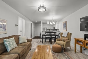The living room offers a comfortable couch and chair.