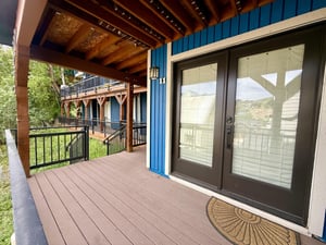 Woodside 11 greets guests with a striking blue exterior and elegant doubledoor entrance.