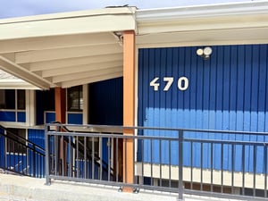 Updated exterior of the Woodside condominium vibrant building with modern mountain styling near Main Street