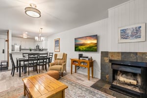 The living room has a wood burning fireplace and flat screen TV.
