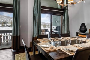 The dining area with seating and table settings for 8 guests.
