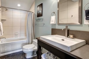 The bathroom with a single sink vanity.