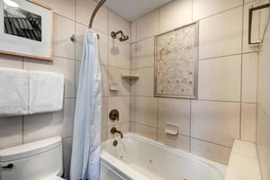 The bathroom offers a bathtub and shower combination.
