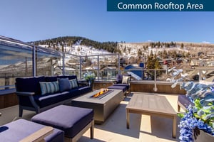 Rio Grandes rooftop sitting area with fire table overlooking snow covered mountains.