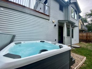 Jetted hot tub in the privacy of the backyard