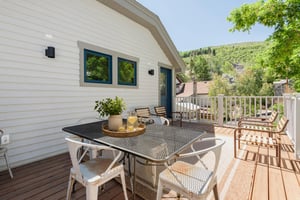 Second floor patio with outdoor chairs and outdoor dining table