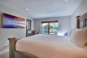 Guest bedroom with queen and wall mounted flat screen TV